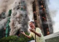 Hong Kong housing complex fire investigation scene showing authorities and damaged high-rise buildings under review.