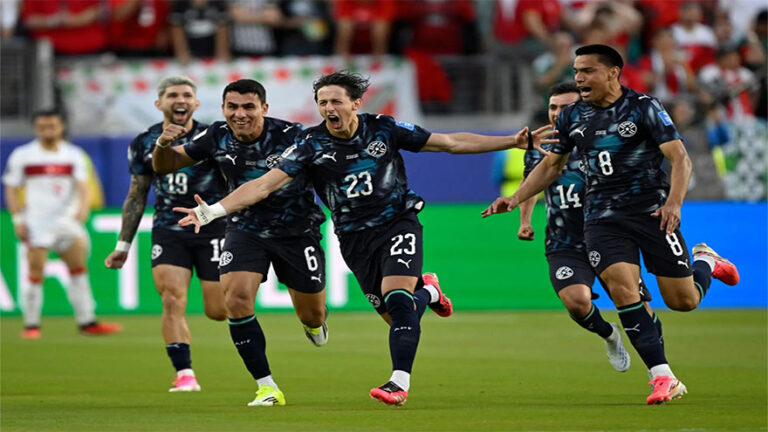 Paraguay players celebrate their victory over Germany after a World Cup knockout match.