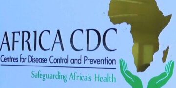 Africa CDC headquarters with officials reviewing pandemic funding and accreditation documents in Addis Ababa.