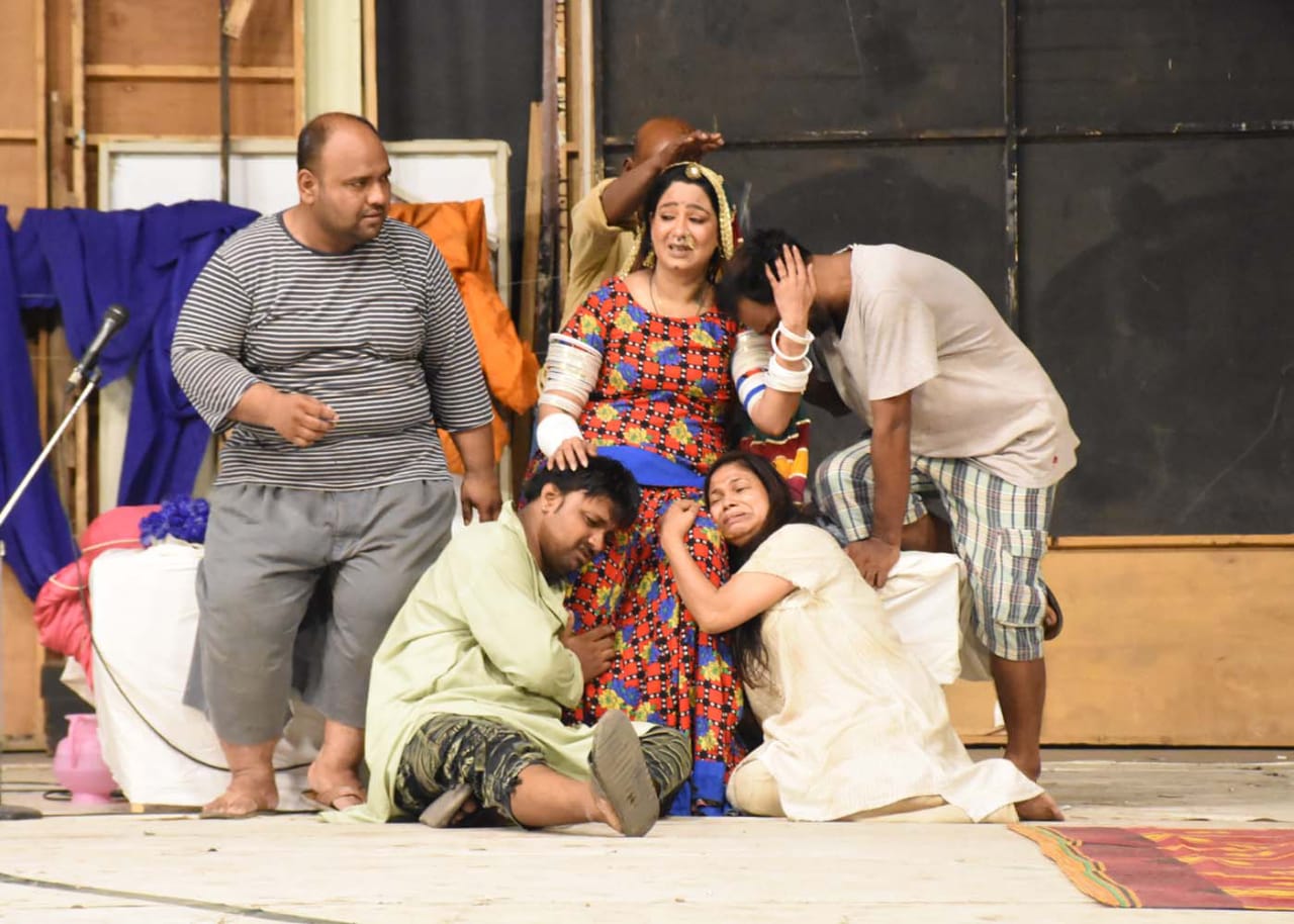 Actors performing on stage during Kunwari Maa theatre play in Karachi with audience watching attentively