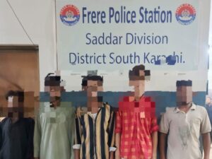 Karachi District South police showing seized stolen motorcycles and weapons after arrest of five-member street crime gang near Frere area.