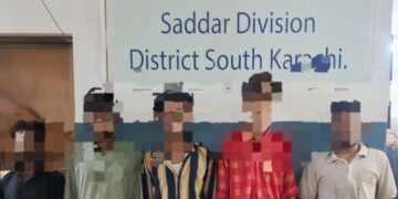 Karachi District South police showing seized stolen motorcycles and weapons after arrest of five-member street crime gang near Frere area.