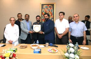 Officials of Pakistan Tanners Association and Sindh government exchange crests during an industry meeting in Karachi.