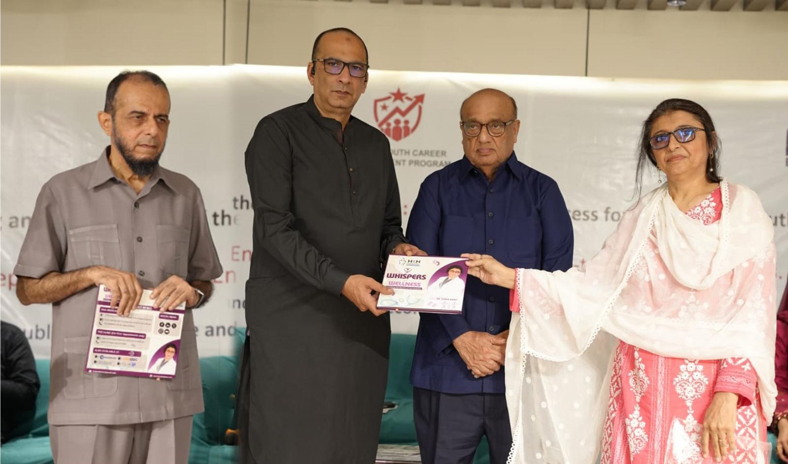 Dr Saira Bano presenting Whispers of Wellness during recognition ceremony.
