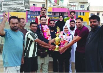 Participants competing in shooting ball and athletics events at Abdul Haq Sports Festival held in Karachi