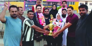 Participants competing in shooting ball and athletics events at Abdul Haq Sports Festival held in Karachi