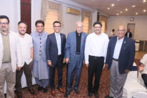 Participants attending a Budget 2026 discussion session in Karachi with speakers addressing economic policy and fiscal planning at a Rotary Club event.