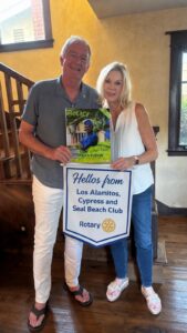 Outgoing and incoming Rotary Club presidents reading the latest issue of Rotary Magazine.