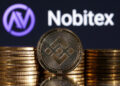 Representations of cryptocurrency Binance are seen in front of displayed Nobitex logo in this illustration taken November 3, 2022. REUTERS/Dado Ruvic/Illustration
