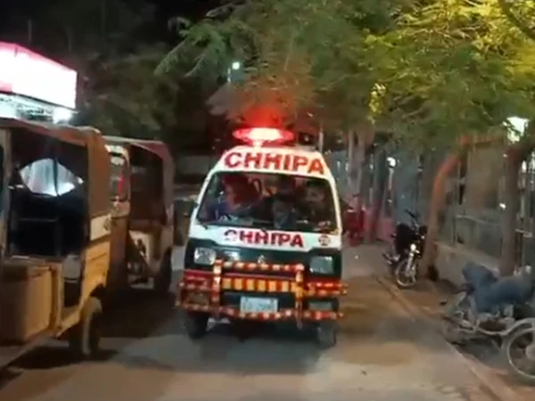 Police officers at the scene of a rickshaw shooting near Clifton Driving Licence Branch in Karachi