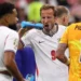 Football players pausing for hydration break during World Cup match in stadium under hot conditions