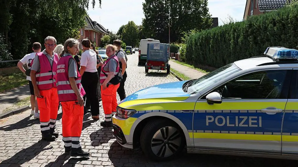 Emergency personnel and police officers respond to the shooting scene in Stade, northern Germany.