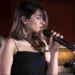 Iranian singer Parastoo Ahmadi performing online music concert linked to reported court sentence over hijab and expression laws.