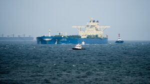 Oil tankers and cargo vessels moving through the Strait of Hormuz after the US-Iran agreement.