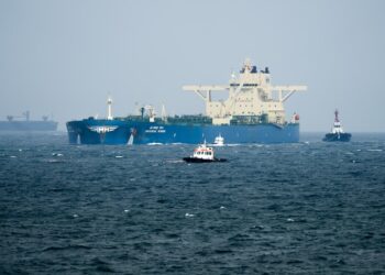 Oil tankers and cargo vessels moving through the Strait of Hormuz after the US-Iran agreement.