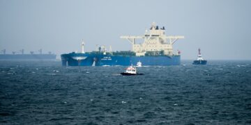Oil tankers and cargo vessels moving through the Strait of Hormuz after the US-Iran agreement.