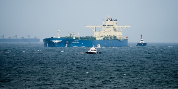 Oil tankers and cargo vessels moving through the Strait of Hormuz after the US-Iran agreement.