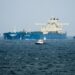 Oil tankers and cargo vessels moving through the Strait of Hormuz after the US-Iran agreement.