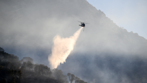 Firefighters and aircraft respond to large wildfires after the United States raises its national wildfire preparedness level to Level 5.