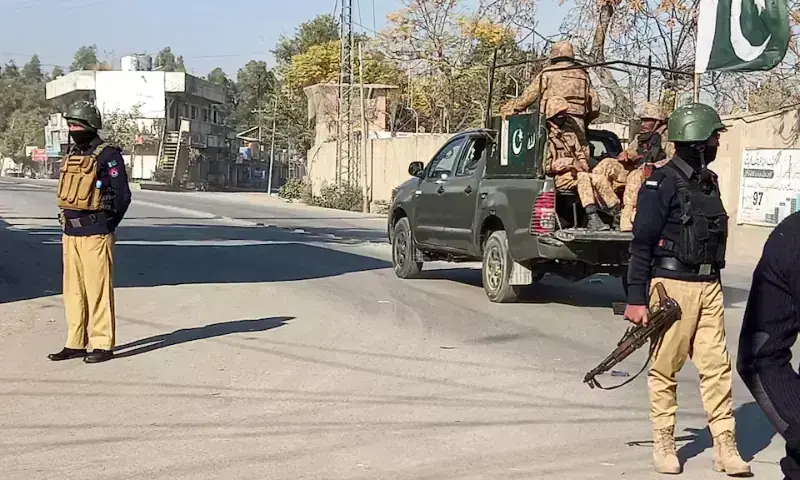Police and security forces at the Khazina Banda checkpost in Hangu following a militant attack that killed nine officers.