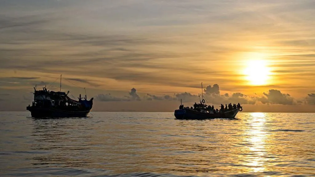 Rohingya refugees board overcrowded boats while fleeing conflict and humanitarian conditions in Myanmar.