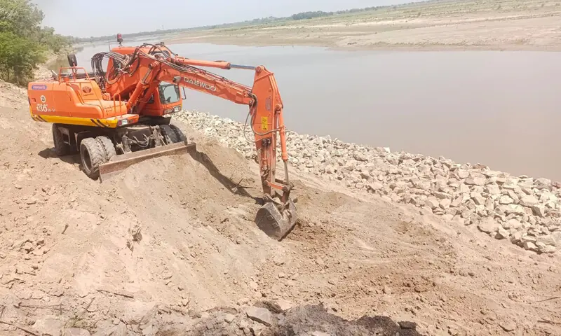Punjab authorities prepare flood protection measures along the Ravi River amid monsoon concerns.