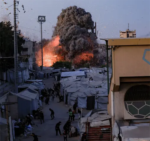 Smoke and debris surround Al-Muttaqin Mosque following an Israeli air strike in Gaza.