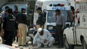 Police secure the area outside a bank in Clifton, Karachi, where a young doctor was killed during an armed robbery.