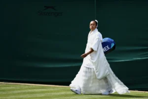 Players and spectators dressed in elegant white outfits during the Wimbledon tennis championships.
