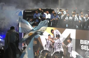 Argentina football team receives a warm welcome from fans in Buenos Aires following the World Cup final defeat.