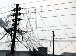 Officials and visitors outside Sindh education offices affected by prolonged power outages in Karachi.