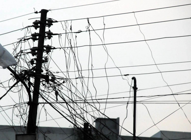 Officials and visitors outside Sindh education offices affected by prolonged power outages in Karachi.
