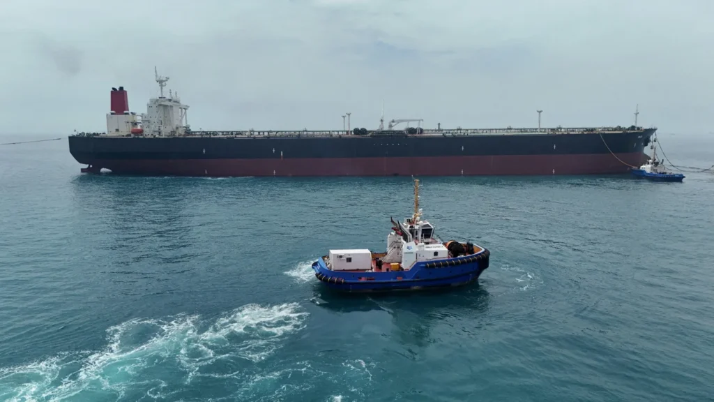 Oil tanker sailing through the Strait of Hormuz as geopolitical tensions push crude prices higher.