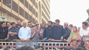 Pakistan Peoples Party District East workers hold banners and party flags during a protest rally against India's alleged water aggression and in support of protecting the Indus River.