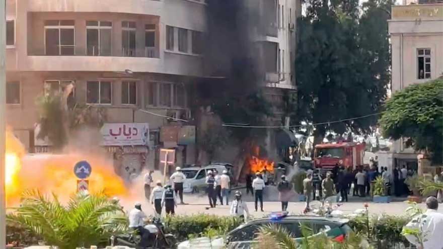 Smoke rises near the Four Seasons Hotel in Damascus after explosions injured several people during Emmanuel Macron's official visit.