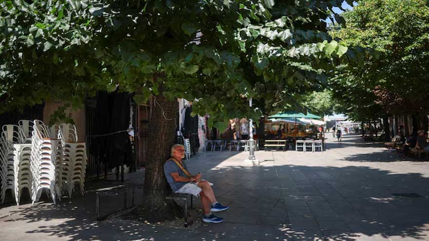 People seek shade during an extreme heatwave as the WHO warns of rising temperatures across Europe.