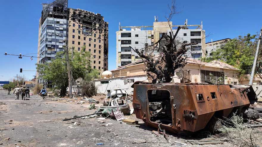 People walk through damaged areas of Khartoum as residents return following the conflict in Sudan.