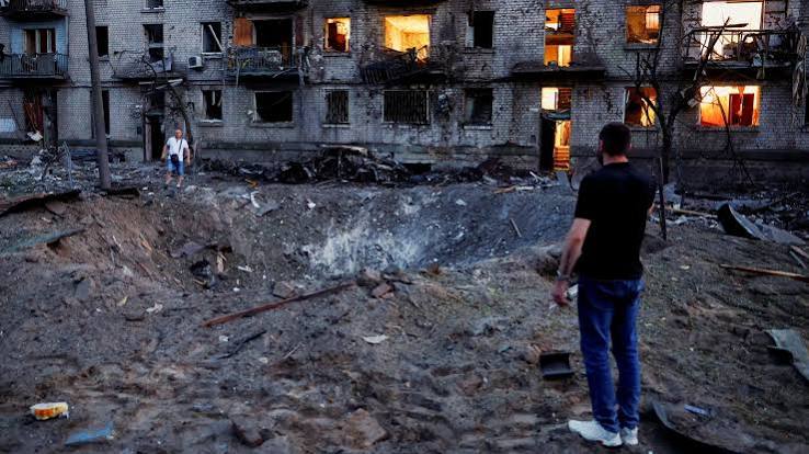 Emergency crews respond to damaged residential buildings following a large-scale Russian missile and drone attack on Kyiv.