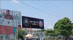 Posters displayed on a road in Mirpur, Azad Kashmir, promoting peace and opposing a banned committee.