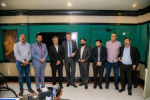 German Consul General Thomas E. Schultze and Pakistani business leaders discussing pharmaceutical exports