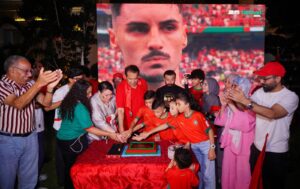 Honorary Consul General Ishtiaq Baig cuts a celebratory cake with Moroccan families and friends after Morocco's FIFA World Cup 2026 victory over Canada.