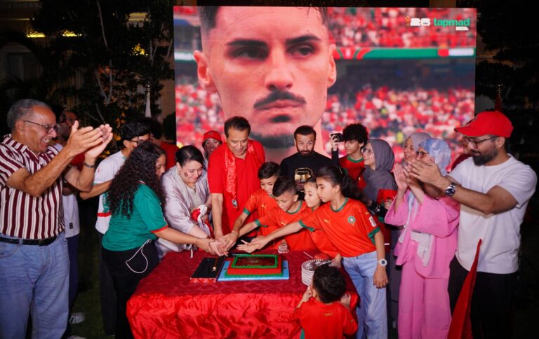 Honorary Consul General Ishtiaq Baig cuts a celebratory cake with Moroccan families and friends after Morocco's FIFA World Cup 2026 victory over Canada.