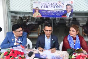 District Governor Shahzad Sabir congratulates the new president of the Rotary Club of Karachi Clifton during the 2026–27 installation ceremony.