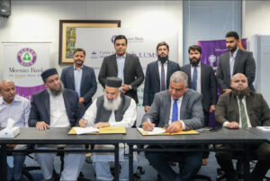 Meezan Bank and LUMS representatives signing an MoU for Islamic finance education partnership in Pakistan.