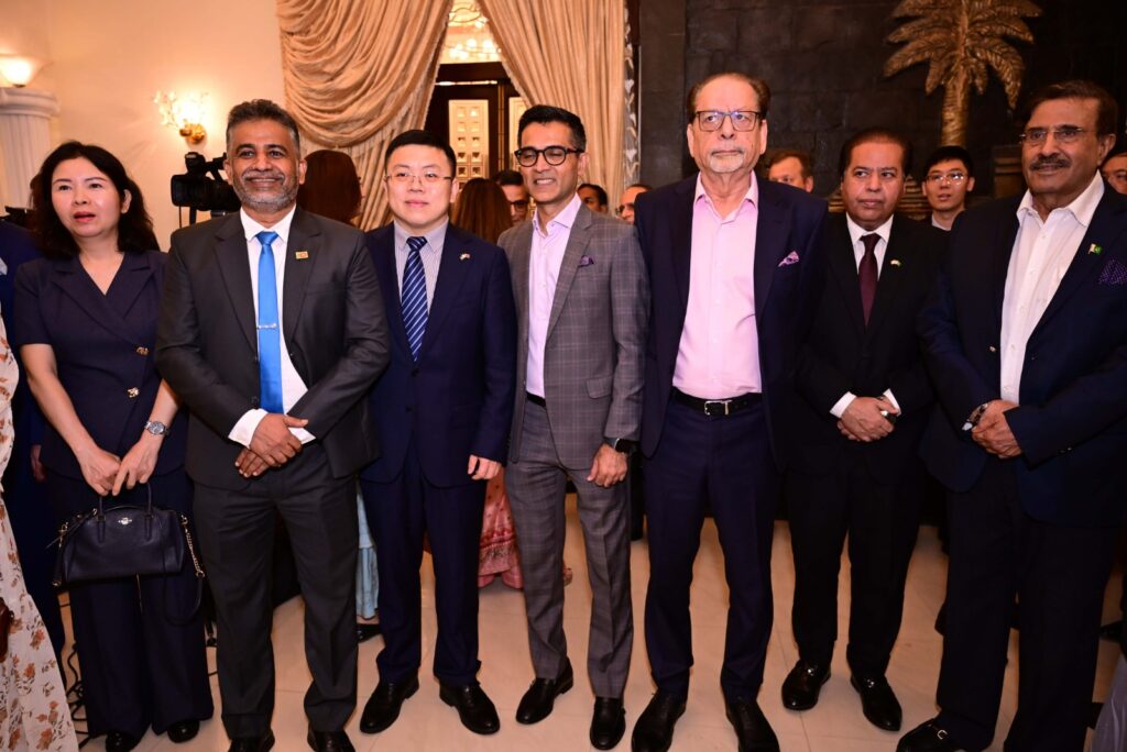 District Governor Shahzad Sabir pins British Deputy Head of Mission Tom Burge at a Rotary District 3271 event.