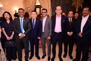 District Governor Shahzad Sabir pins British Deputy Head of Mission Tom Burge at a Rotary District 3271 event.
