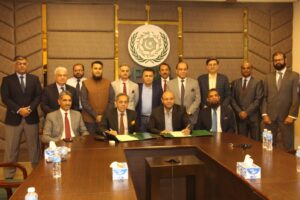 Senior officials from PPCBL and AutoSoft Dynamics during the signing ceremony for the Loan Origination System implementation agreement.