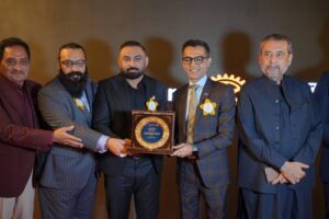 District Governor Shahzad Sabir receives a commemorative shield during the Rotary Club of Karachi Quaid installation ceremony led by President Adnan Syed Raja.