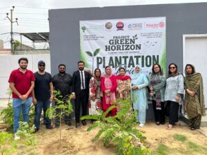 Participants plant saplings during the Project Green Horizon launch at KIET University Ahsanabad Campus in Karachi.