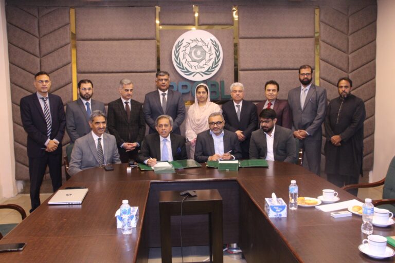 Officials from PPCBL and PaySys Labs exchange documents after signing a partnership agreement for a next-generation mobile banking application and RTGS platform.